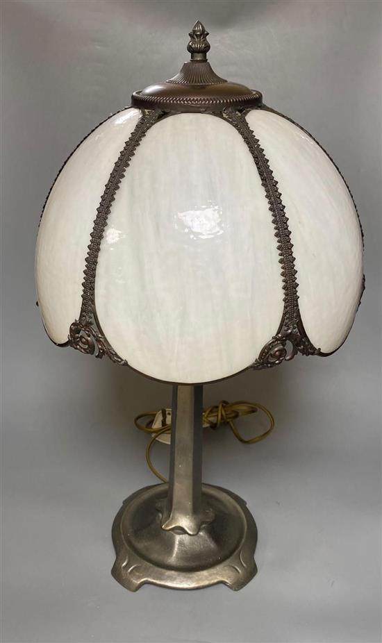 An Art Nouveau style metal table lamp with opaque white glass petal shade